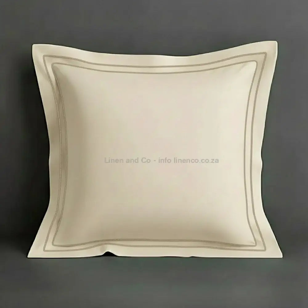 Cream continental oxford pillow case with stone two row satin stitch detail on a grey background. Luxury Hotel Linen by Linen and Co.
