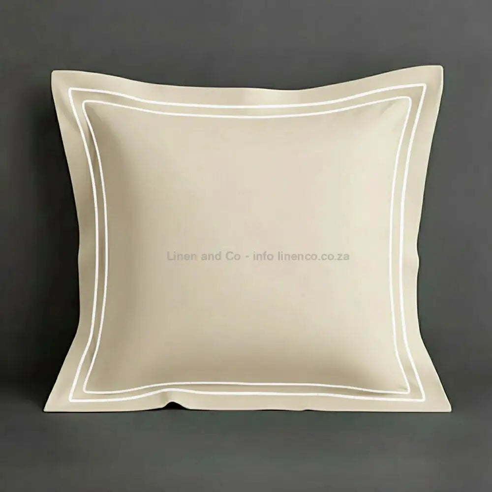 Cream continental oxford pillow case with white two row satin stitch detail on a grey background. Luxury Hotel Linen by Linen and Co.