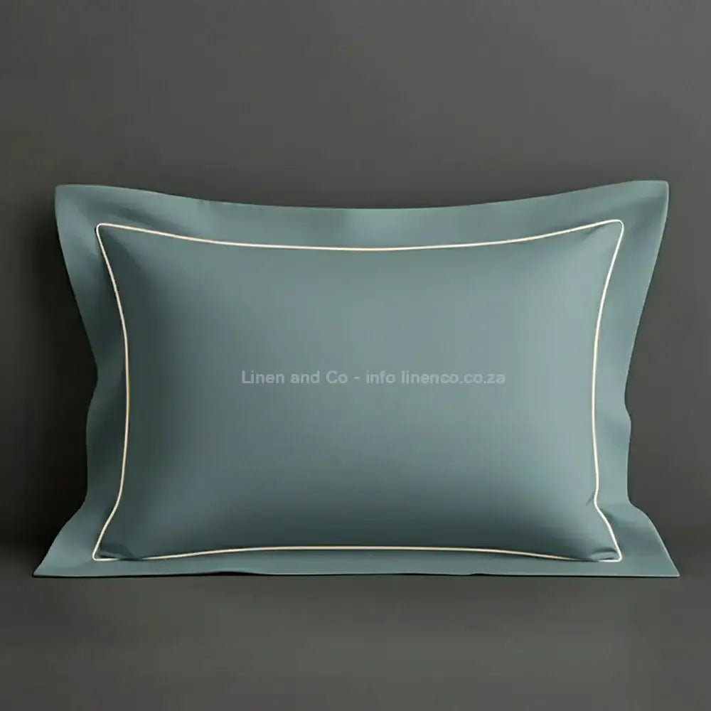 Duck Egg oxford pillow case with cream one row satin stitch detail on a grey background. Luxury Hotel Linen by Linen and Co.