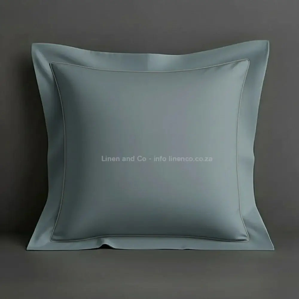 Duck Egg continental oxford pillow case with grey one row satin stitch detail on a grey background. Luxury Hotel Linen by Linen and Co.