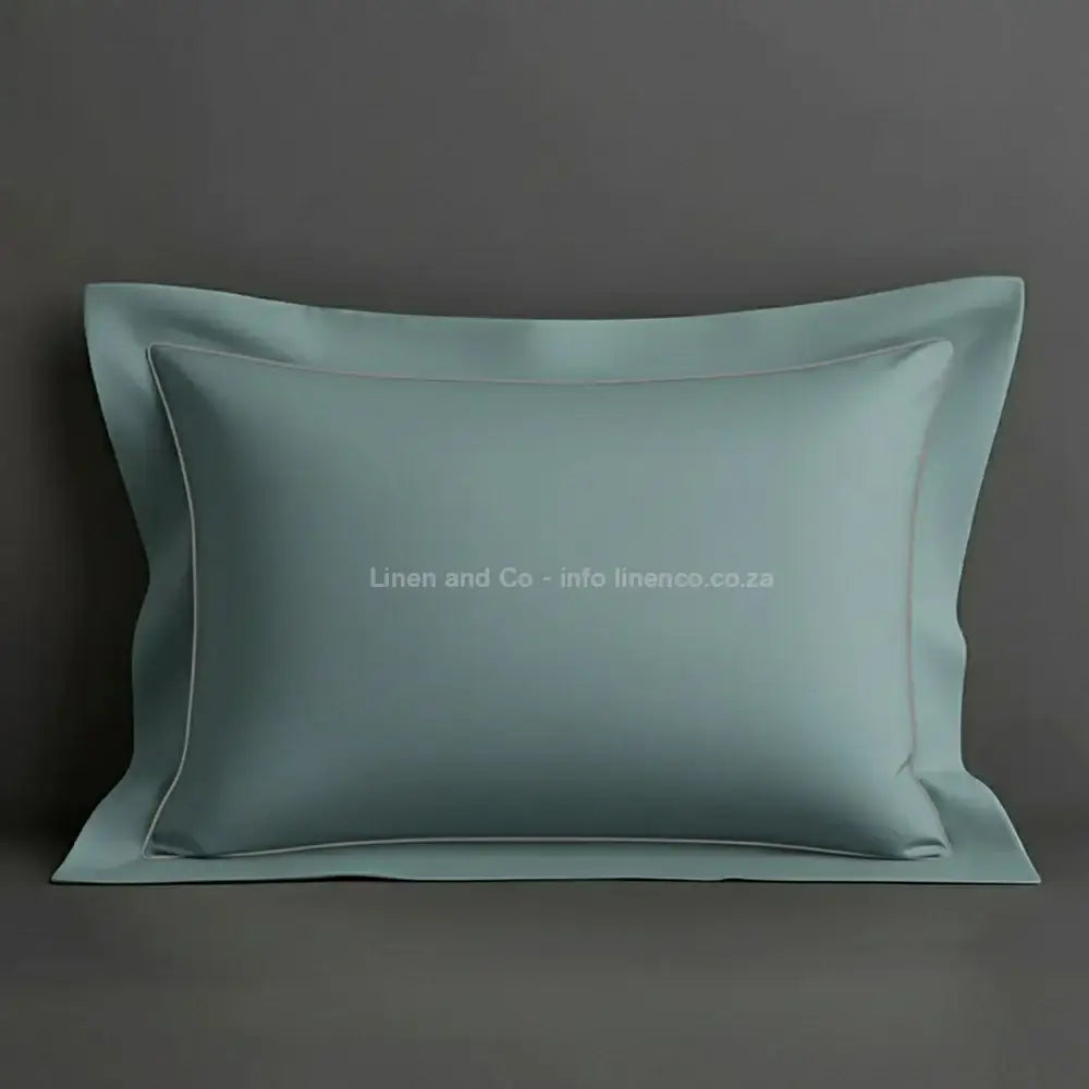 Duck Egg oxford pillow case with grey one row satin stitch detail on a grey background. Luxury Hotel Linen by Linen and Co.