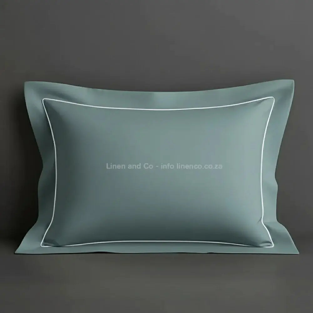 Duck Egg oxford pillow case with white one row satin stitch detail on a grey background. Luxury Hotel Linen by Linen and Co.