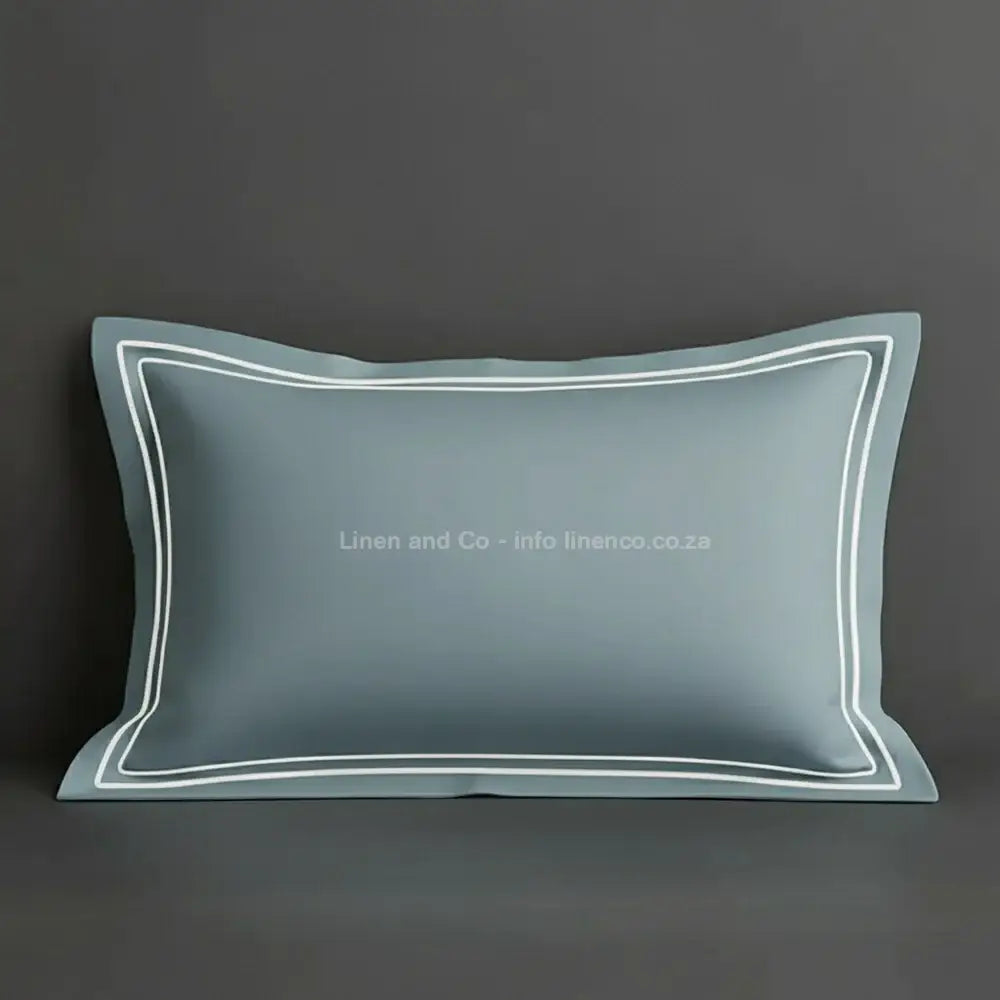 Duck Egg oxford pillow case with white two row satin stitch detail on a grey background. Luxury Hotel Linen by Linen and Co.