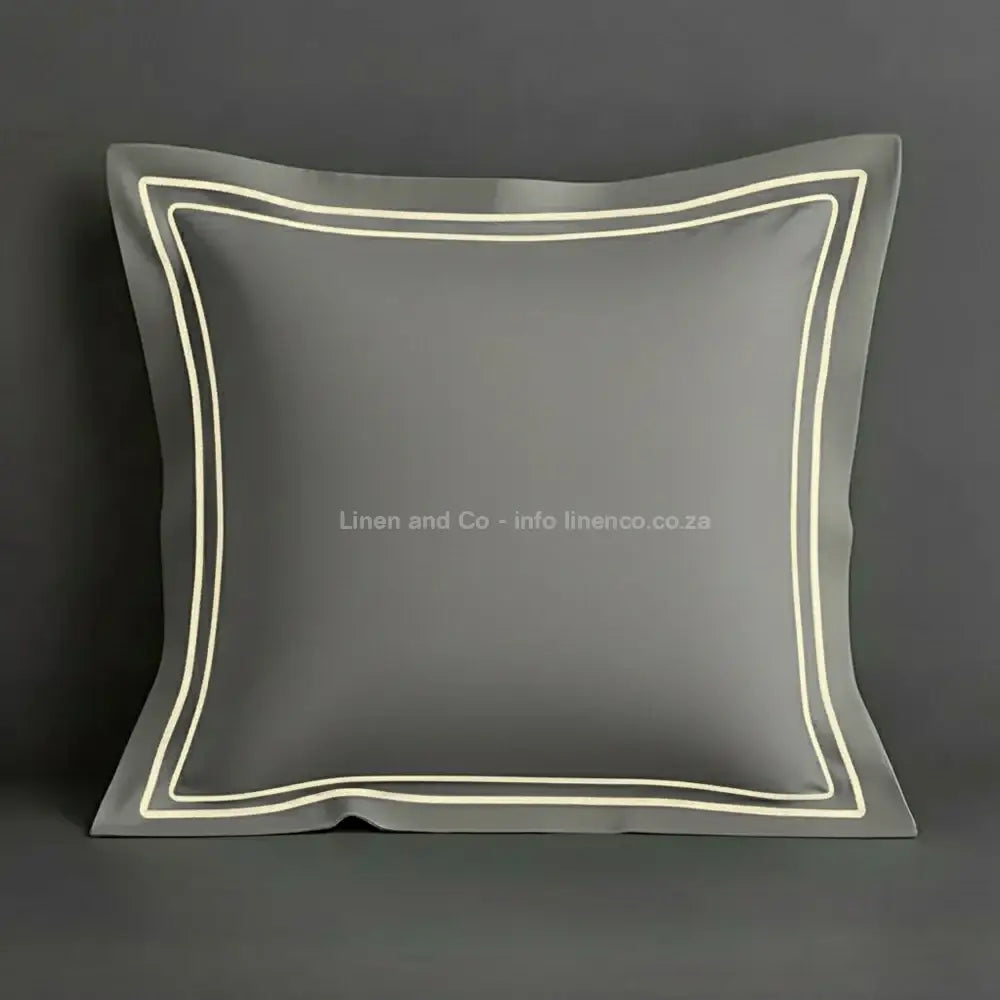Stone continental oxford pillow case with cream two row satin stitch detail on a grey background. Luxury Hotel Linen by Linen and Co.