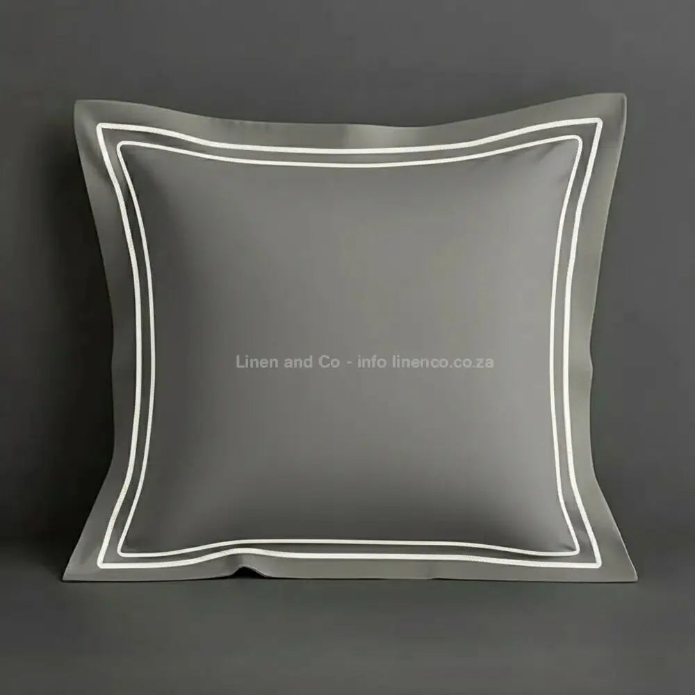 Grey continental oxford pillow case with white two row satin stitch detail on a grey background. Luxury Hotel Linen by Linen and Co.