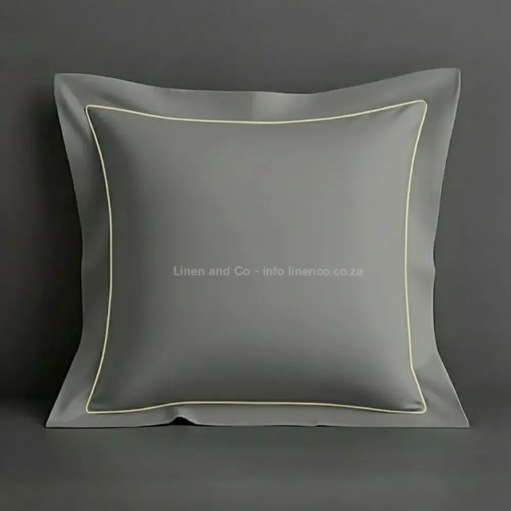 Grey continental oxford pillow case with cream one row satin stitch detail on a grey background. Luxury Hotel Linen by Linen and Co.