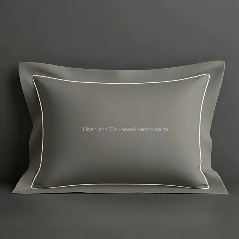 Grey oxford pillow case with cream one row satin stitch detail on a grey background. Luxury Hotel Linen by Linen and Co.