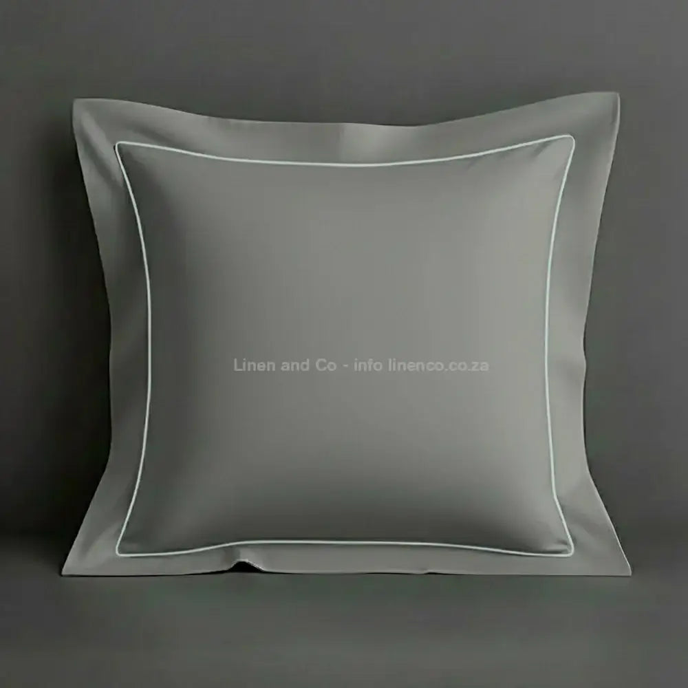 Grey continental oxford pillow case with  duck egg one row satin stitch detail on a grey background. Luxury Hotel Linen by Linen and Co.
