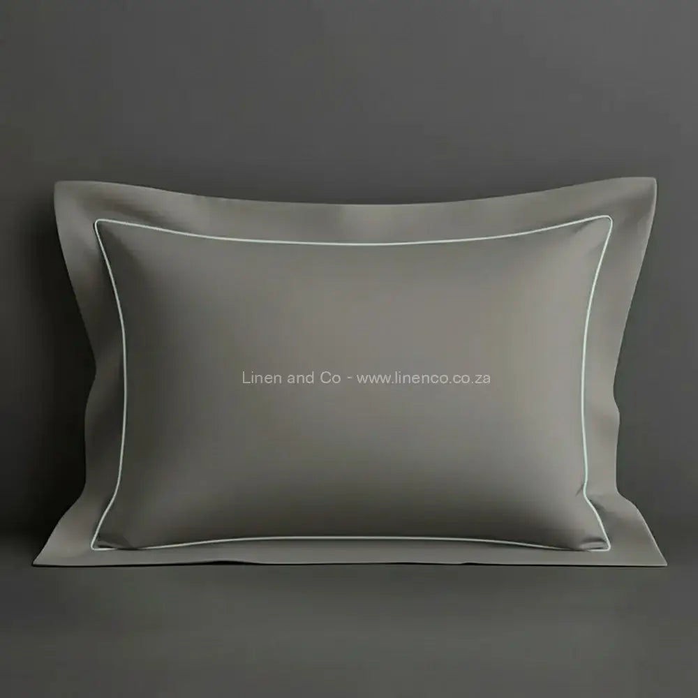 Grey oxford pillow case with duck egg one row satin stitch detail on a grey background. Luxury Hotel Linen by Linen and Co.