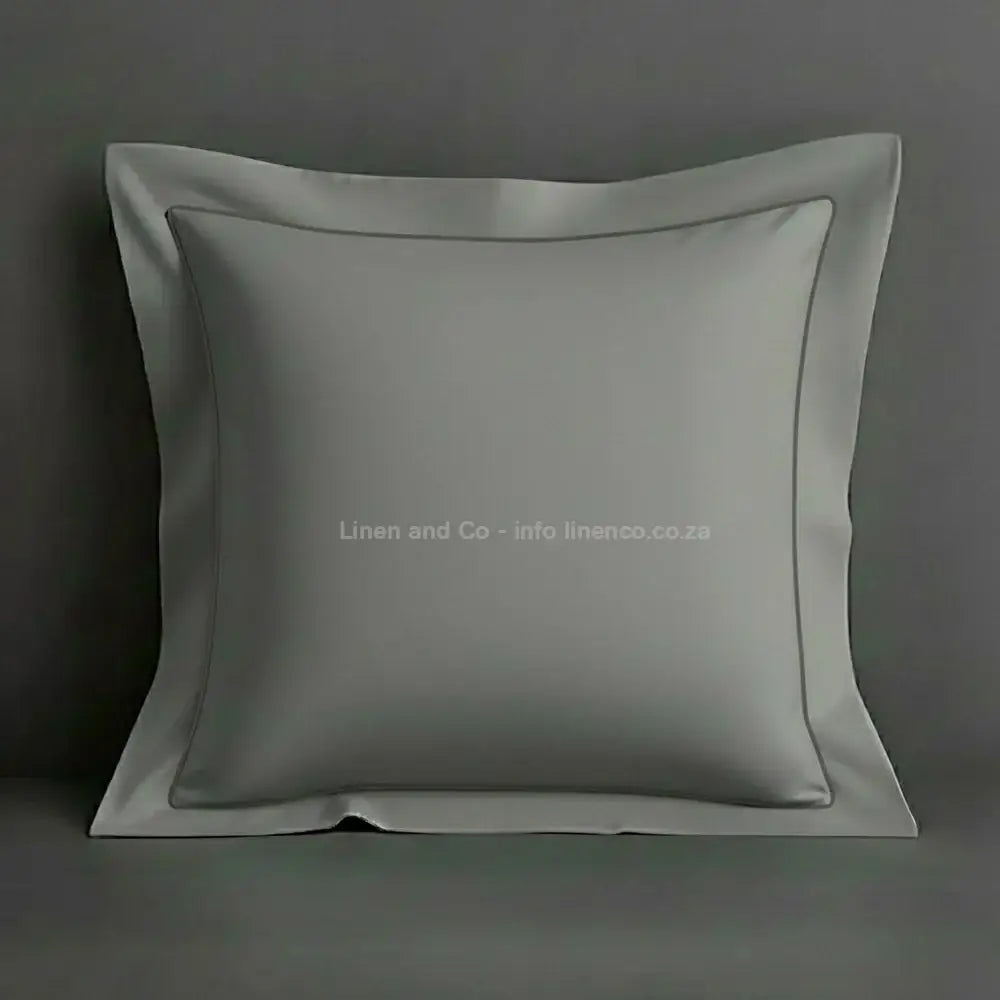 Grey continental oxford pillow case with grey one row satin stitch detail on a grey background. Luxury Hotel Linen by Linen and Co.