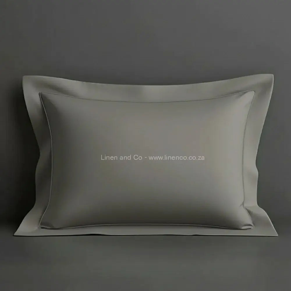 Grey oxford pillow case with grey one row satin stitch detail on a grey background. Luxury Hotel Linen by Linen and Co.
