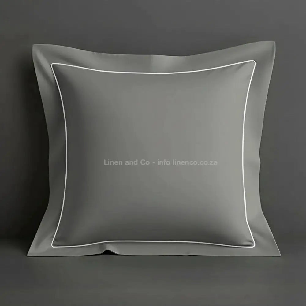 Grey continental oxford pillow case with white one row satin stitch detail on a grey background. Luxury Hotel Linen by Linen and Co.