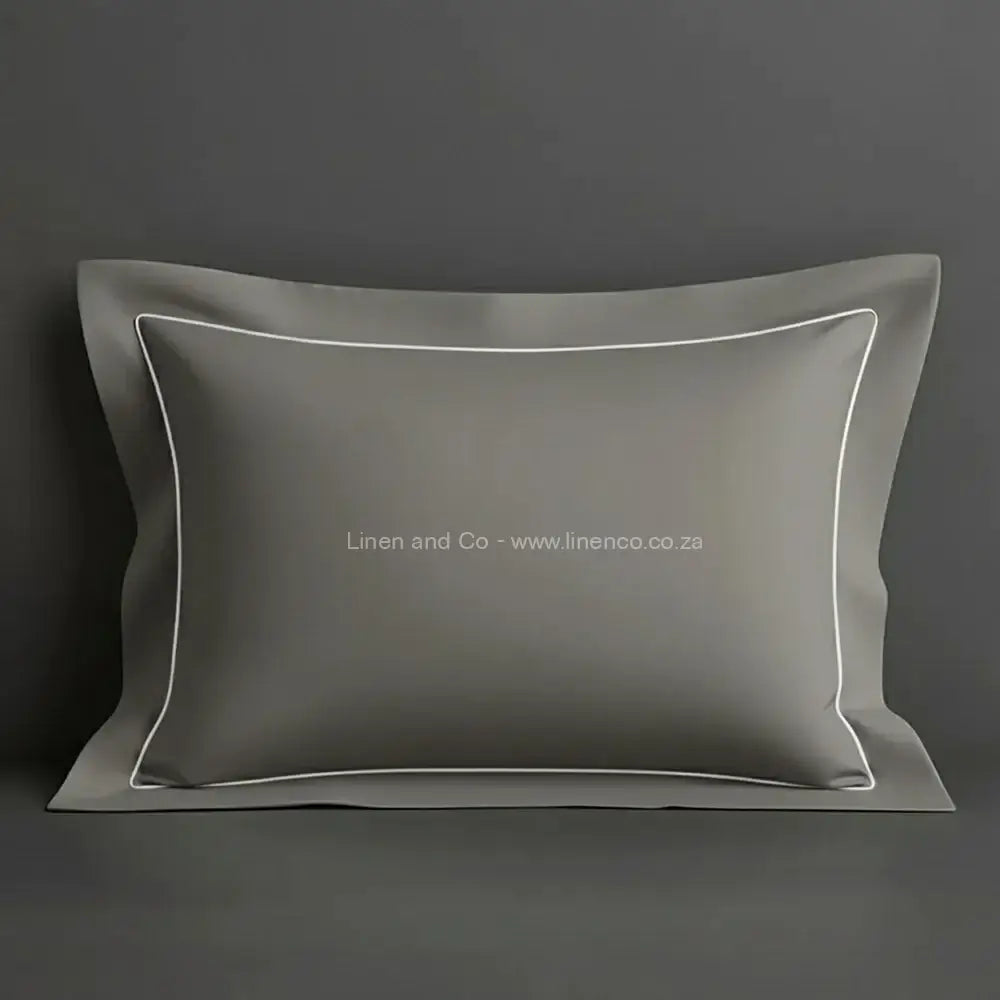 Grey oxford pillow case with white one row satin stitch detail on a grey background. Luxury Hotel Linen by Linen and Co.
