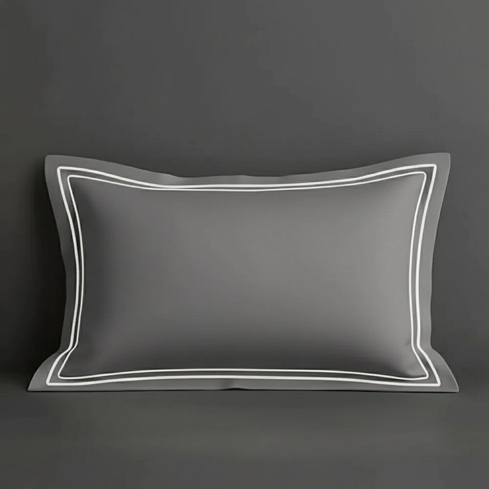 Grey oxford pillow case with two row satin stitch detail on a grey background. Luxury Hotel Linen by Linen and Co.