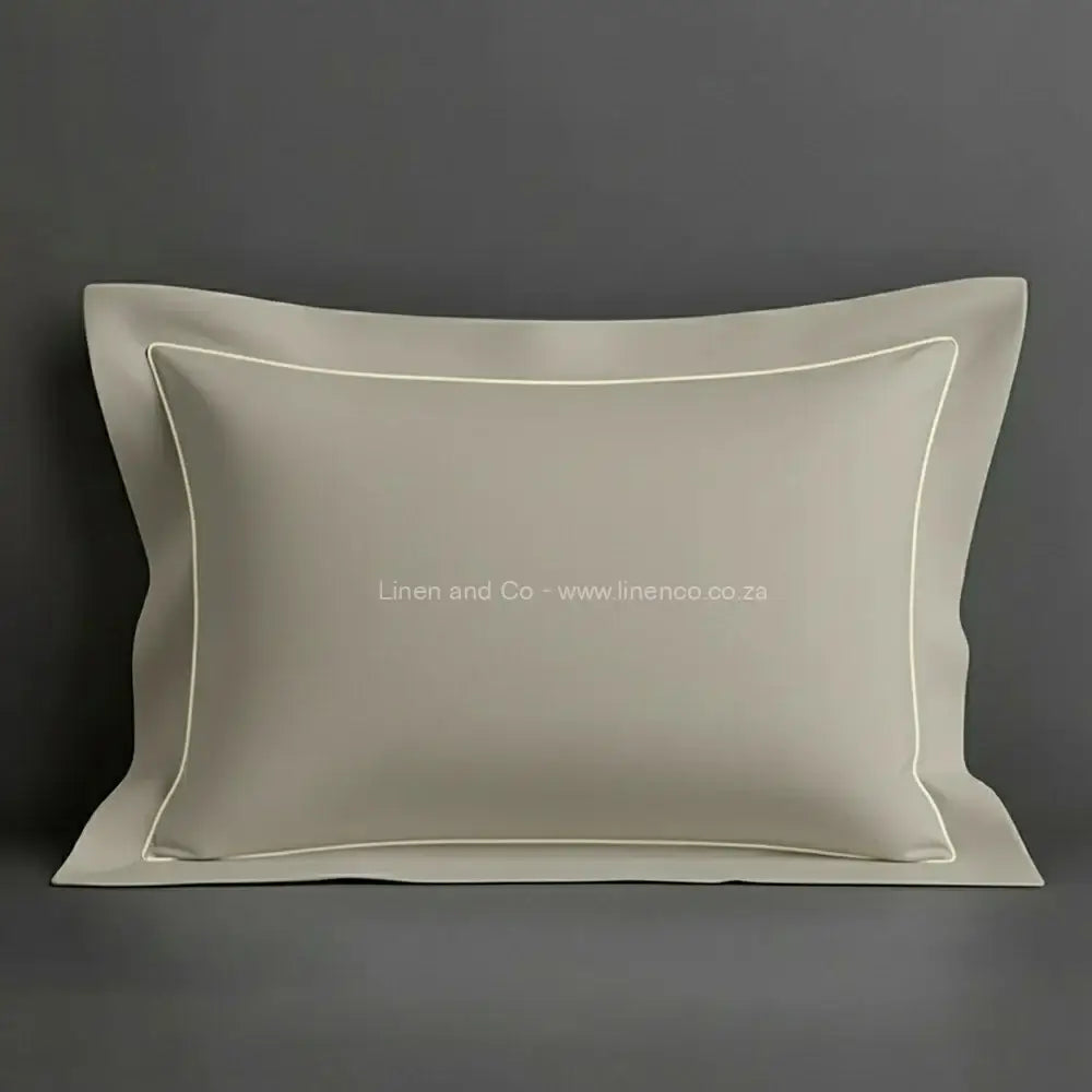 Stone oxford pillow case with cream one row satin stitch detail on a grey background. Luxury Hotel Linen by Linen and Co.