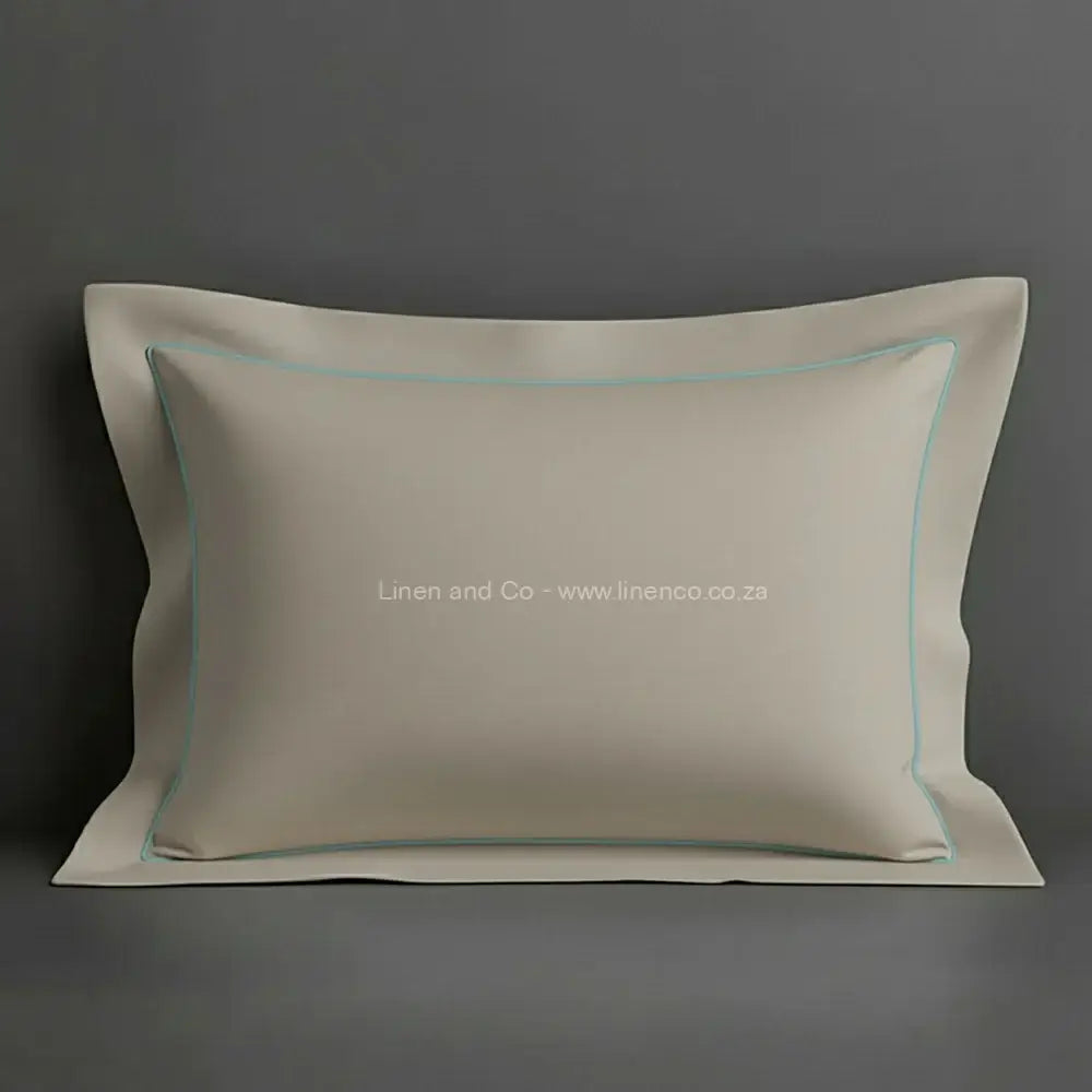 Stone oxford pillow case with duck egg one row satin stitch detail on a grey background. Luxury Hotel Linen by Linen and Co.