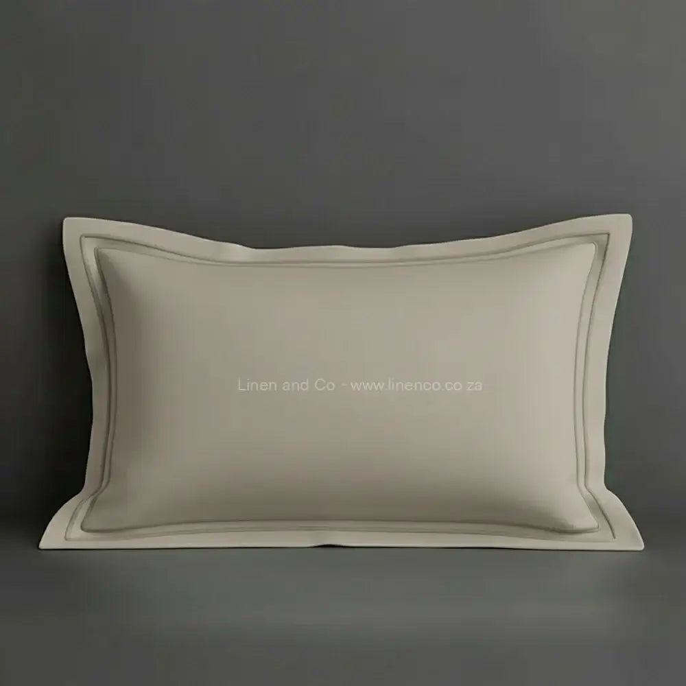Stone oxford pillow case with stone two row satin stitch detail on a grey background. Luxury Hotel Linen by Linen and Co.