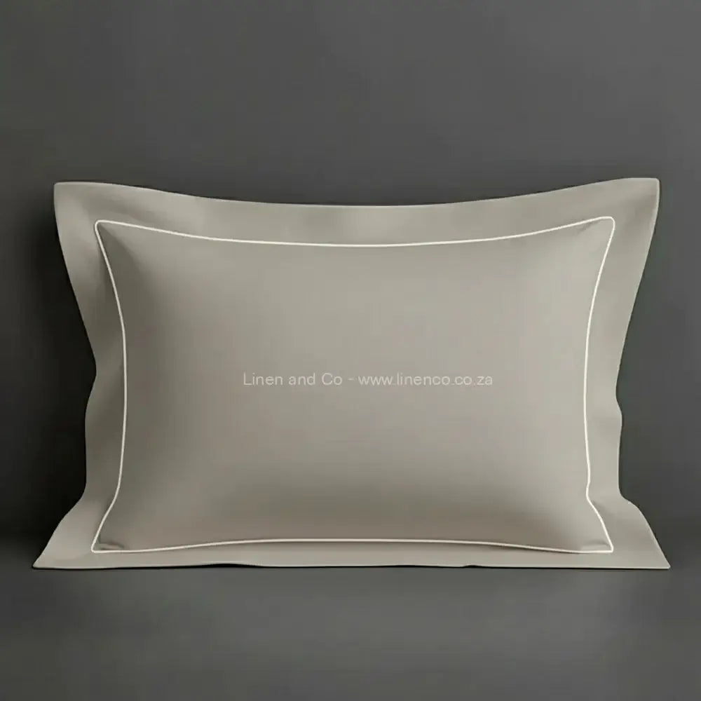 Stone oxford pillow case with white one row satin stitch detail on a grey background. Luxury Hotel Linen by Linen and Co.