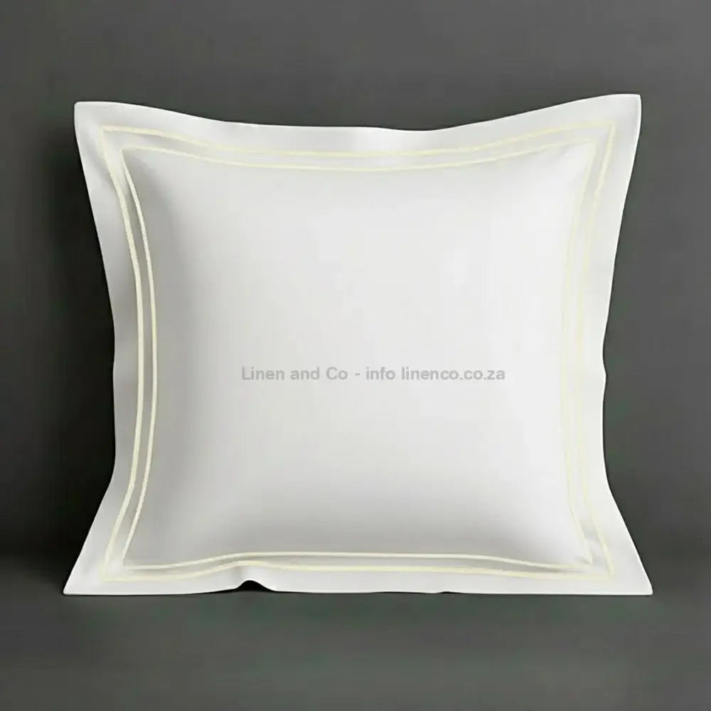 White continental oxford pillow case with cream two row satin stitch detail on a grey background. Luxury Hotel Linen by Linen and Co.