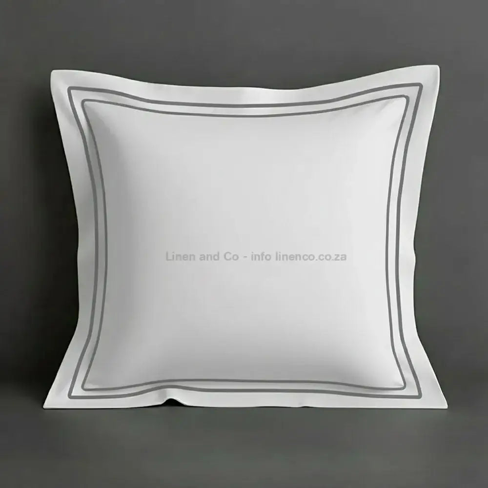 White continental oxford pillow case with grey two row satin stitch detail on a grey background. Luxury Hotel Linen by Linen and Co.