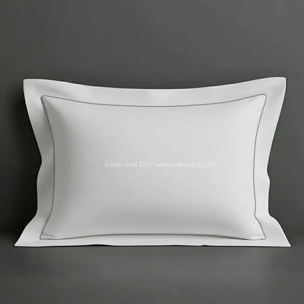 White oxford pillow case with grey one row satin stitch detail on a grey background. Luxury Hotel Linen by Linen and Co.