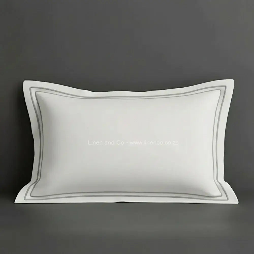 White oxford pillow case with grey two row satin stitch detail on a grey background. Luxury Hotel Linen by Linen and Co.
