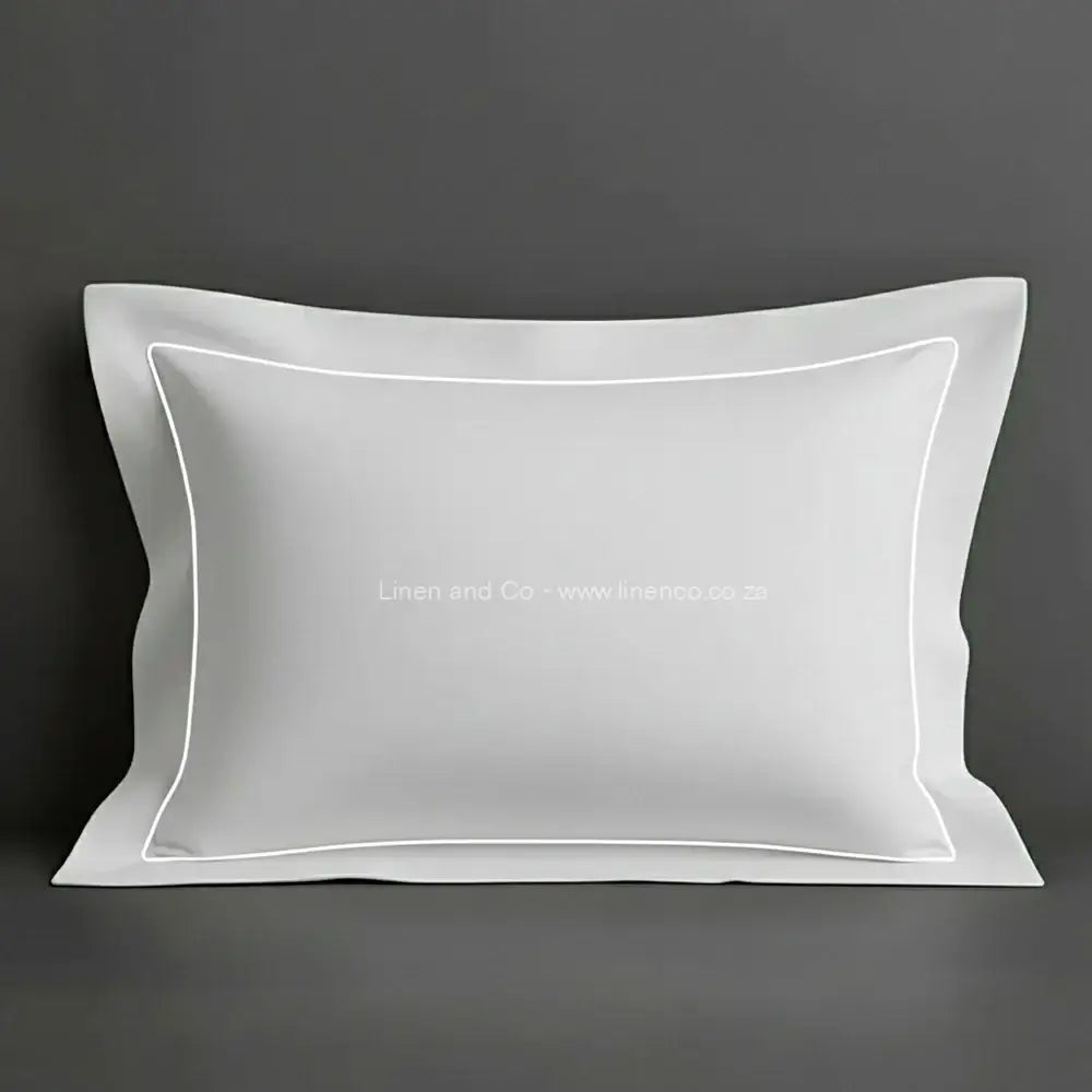 White oxford pillow case with white one row satin stitch detail on a grey background. Luxury Hotel Linen by Linen and Co.