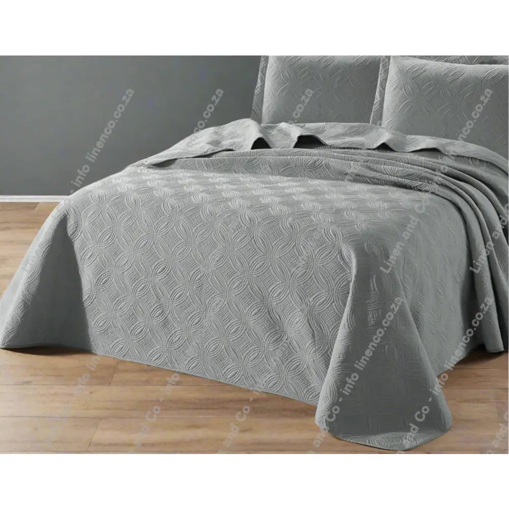 Platinum grey Munich design quilted bedspread textured bedspread on a bed. 