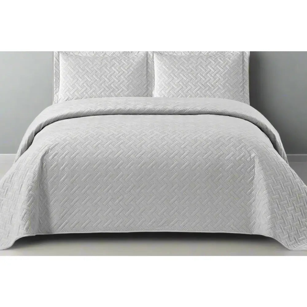 Grey Italian Velvet quilted bedspread set on a bed with matching pillows