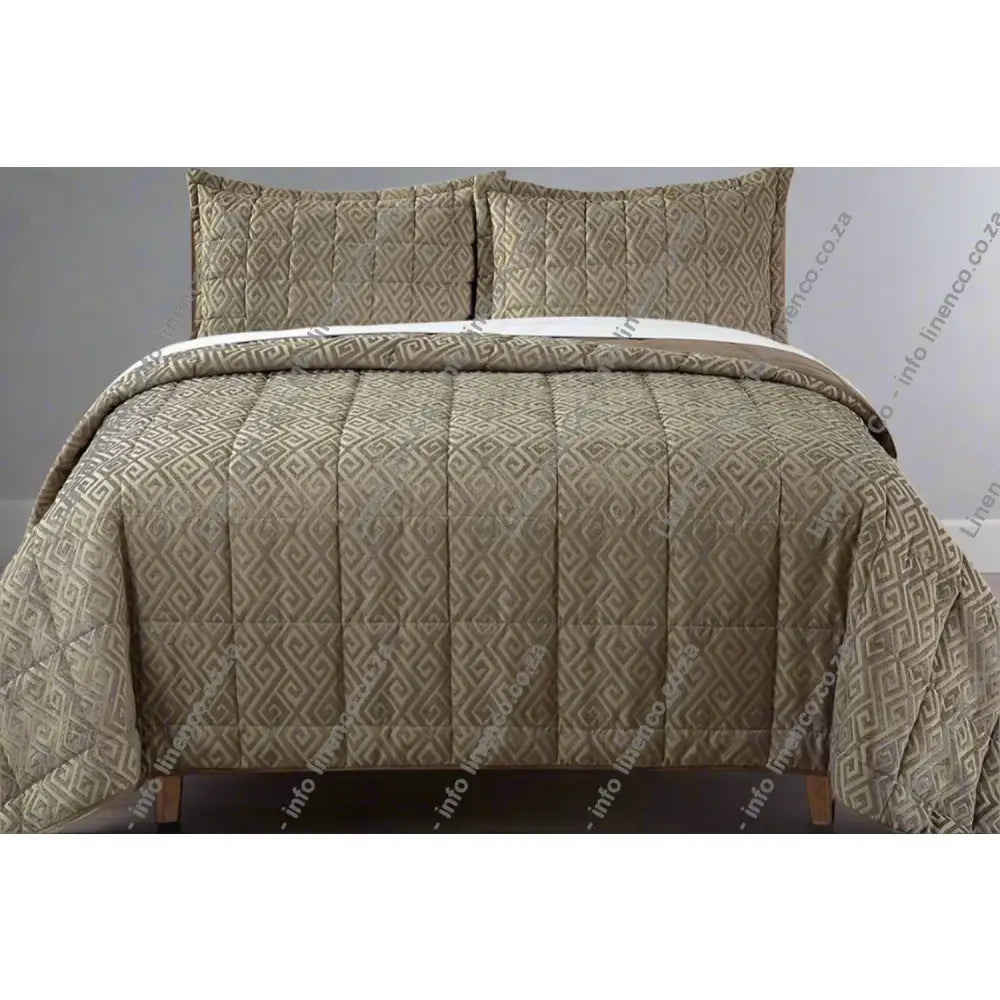 Stone Cambridge design chenille quilt set on a bed with matching pillows.