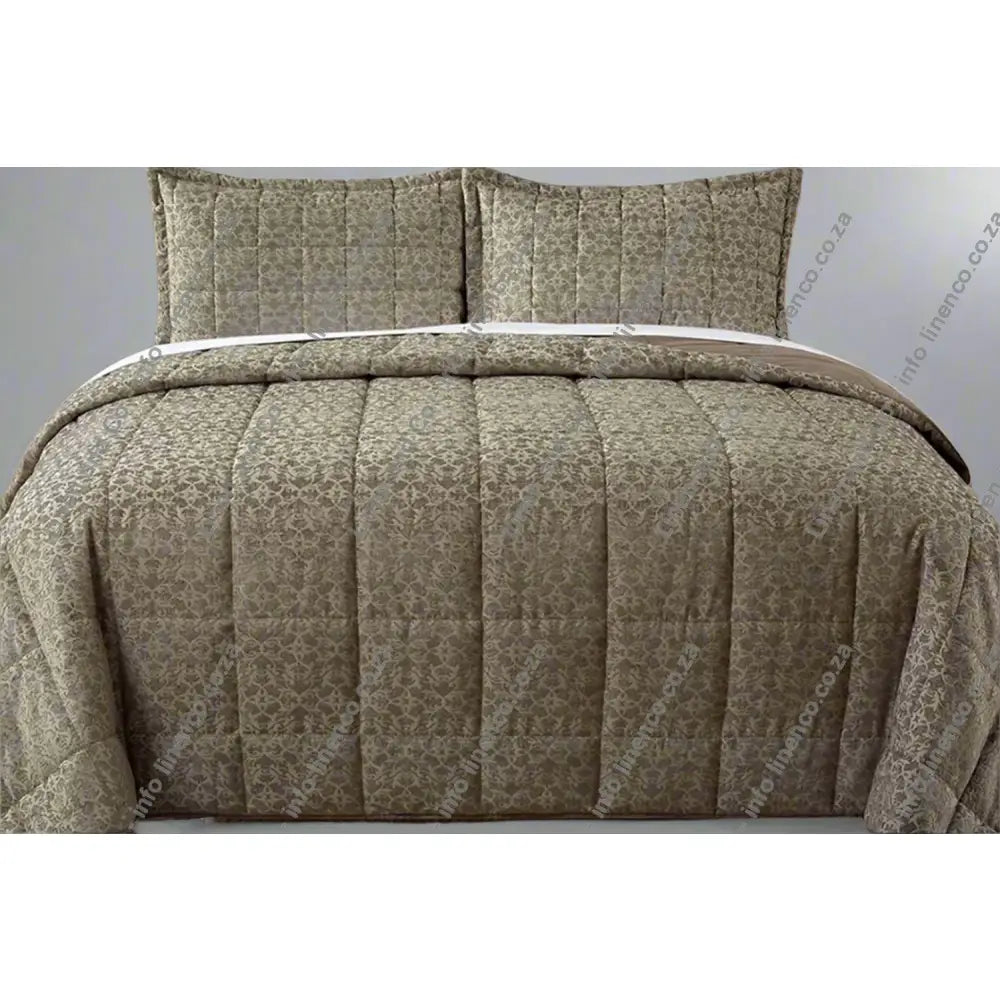 Stone Cologne Design quilted comforter set on a bed with matching pillows.