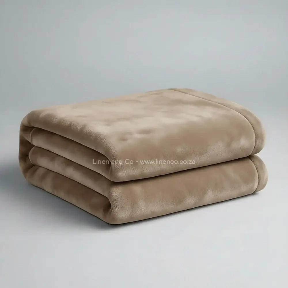 Stone luxury plush blanket neatly folded on light grey background - Linen and Co premium microfibre hospitality blanket