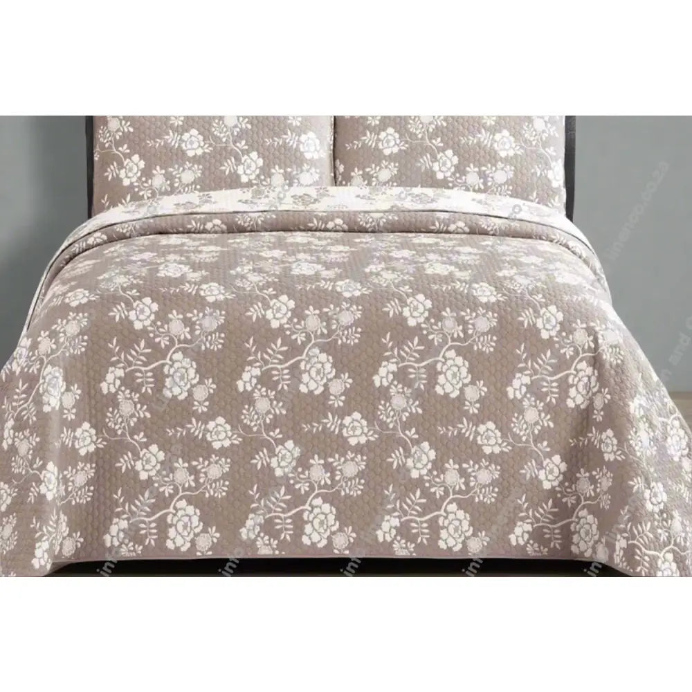 Rochelle Design Floral patterned denim quilt on a bed with matching pillows.
