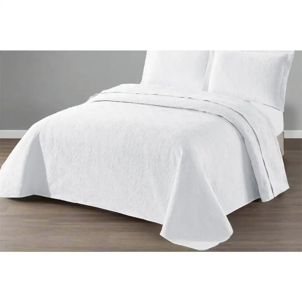 White Daisy Design Quilted bedspread on a bed with a grey wall background