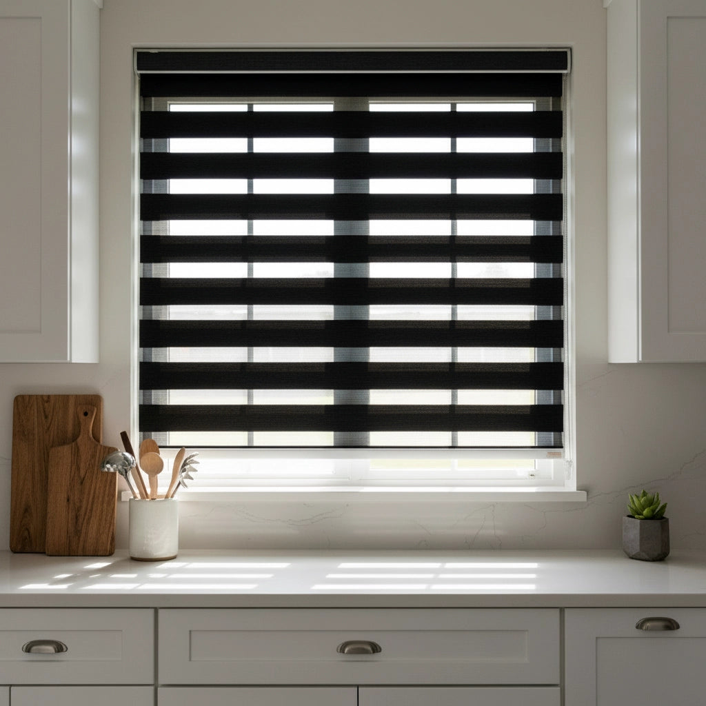 Black zebra blinds with alternating sheer and opaque stripes in a modern kitchen window by Linen and Co