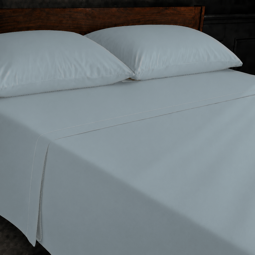 Duck Egg polycotton percale 200TC flat sheet with Natural Cream one-row satin stitch — on the bed.