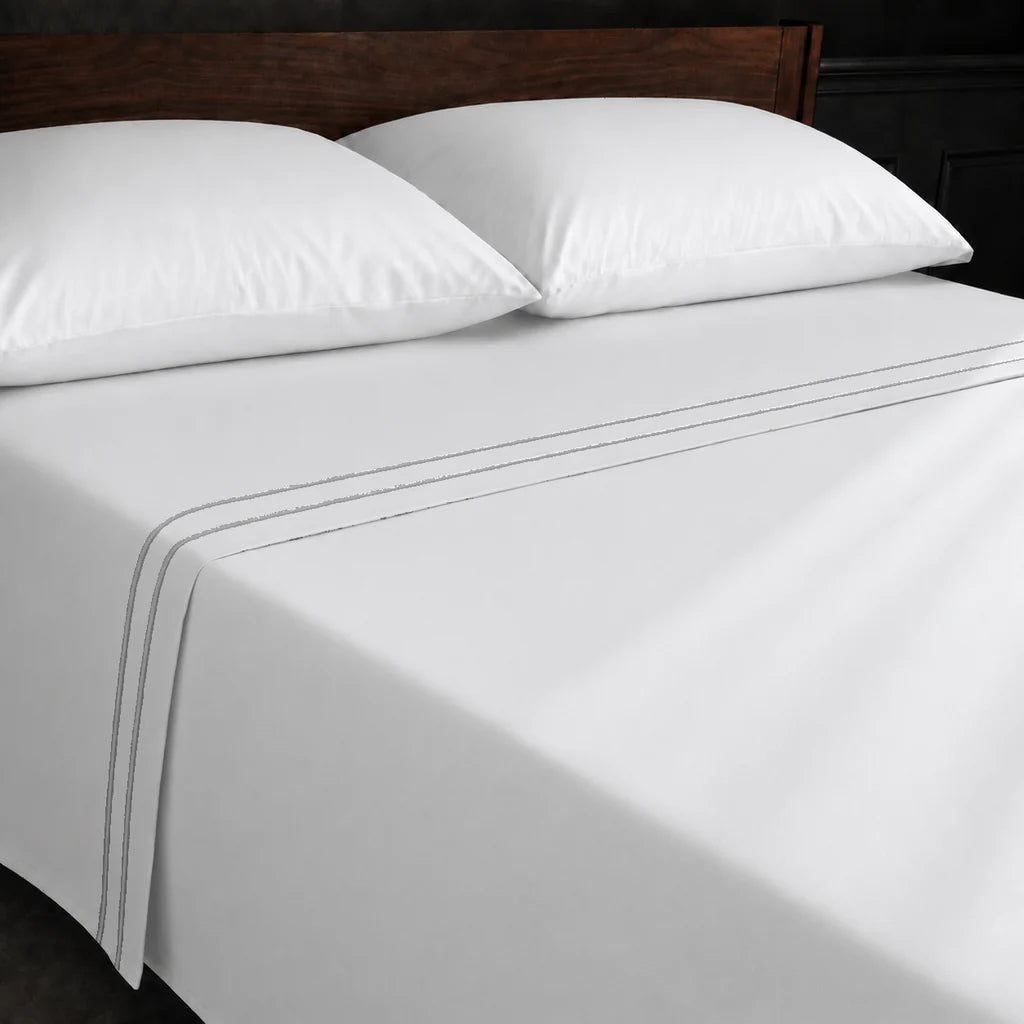 White Polycotton Percale 200TC flat sheet with Grey two row satin stitch - on the bed - Linen and Co