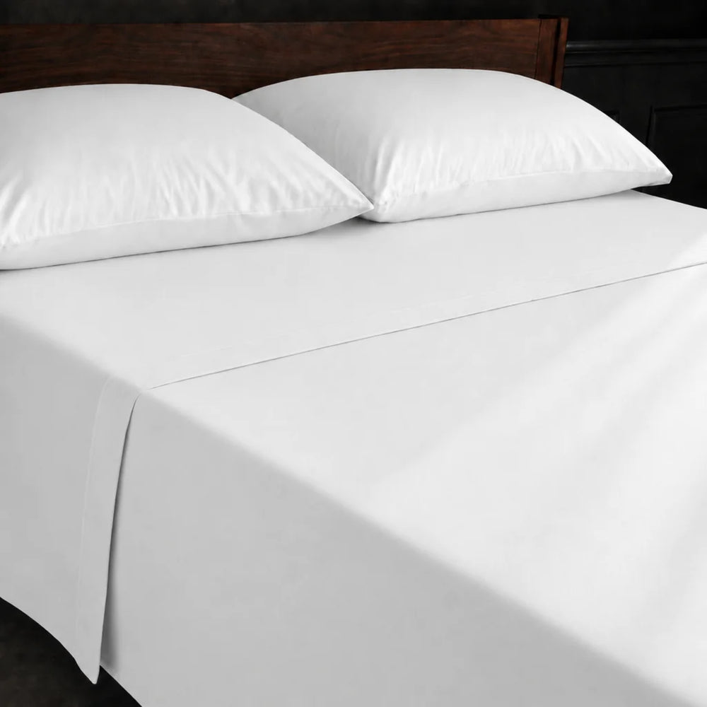 White Polycotton Percale 200TC flat sheet with no satin stitch - on the bed - Linen and Co