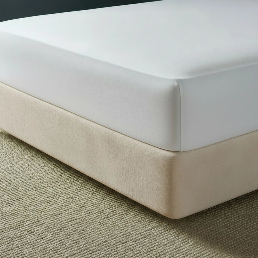 beige mock suede base wrap covering bed base with white fitted sheet on beige jute mat—luxury bed base cover by Linen & Co
