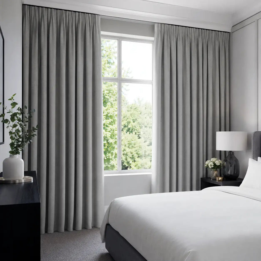 Greystone blockout curtains create a calm bedroom with practical room-darkening comfort.