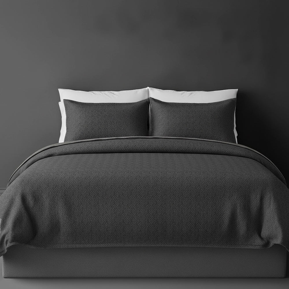 Charcoal Grey Rome bedspread on bed by Linen and Co - luxury hospitality bedspread with textured finish