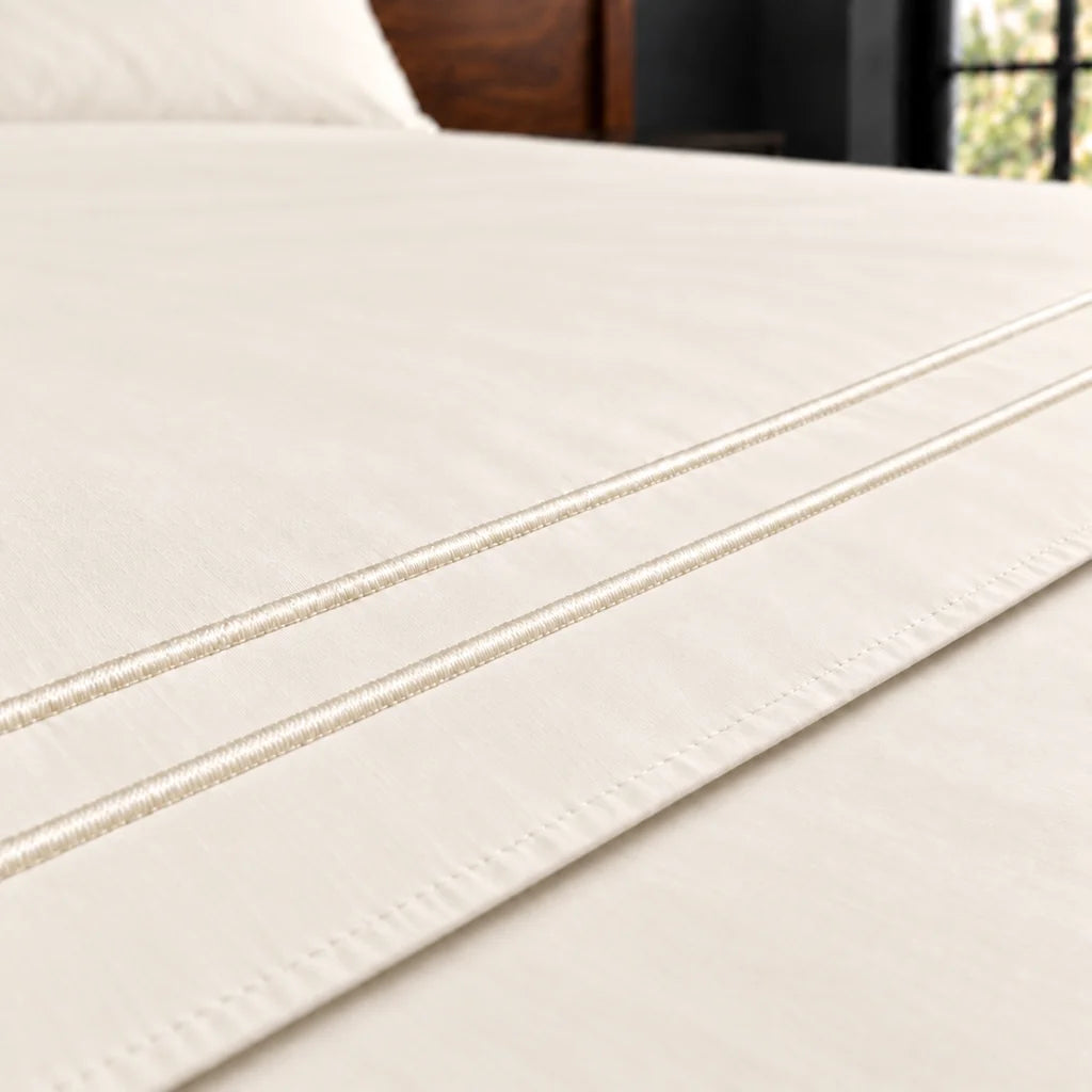 cream cotton percale 200tc flat sheet, two row cream satin stitch — close up — Linen and Co
