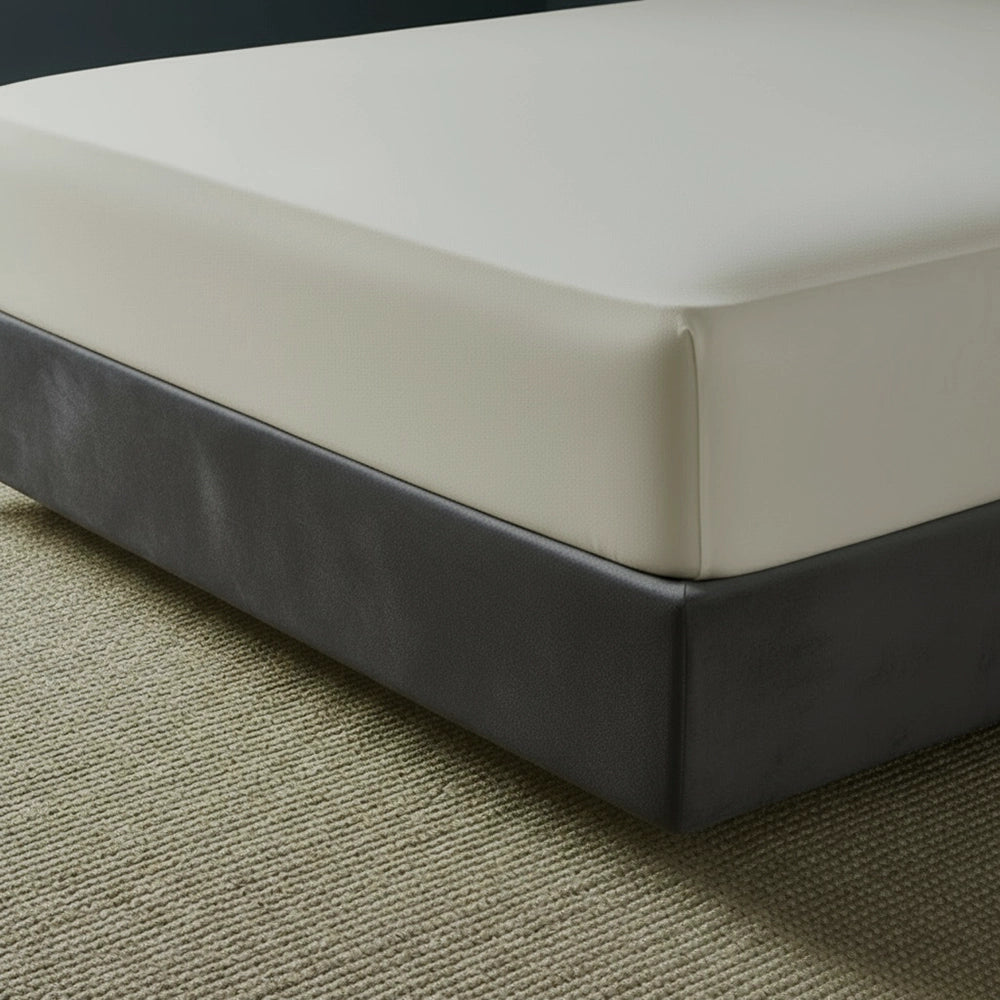 Cream fitted sheet on grey bed frame by Linen and Co - premium hospitality bed linen
