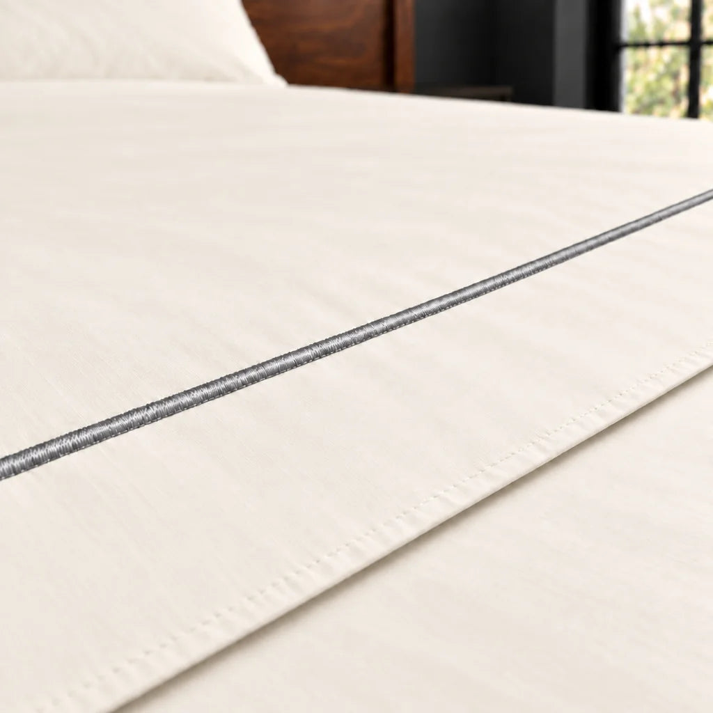 cream polycotton percale 200tc flat sheet, one row grey satin stitch — close up — Linen and Co