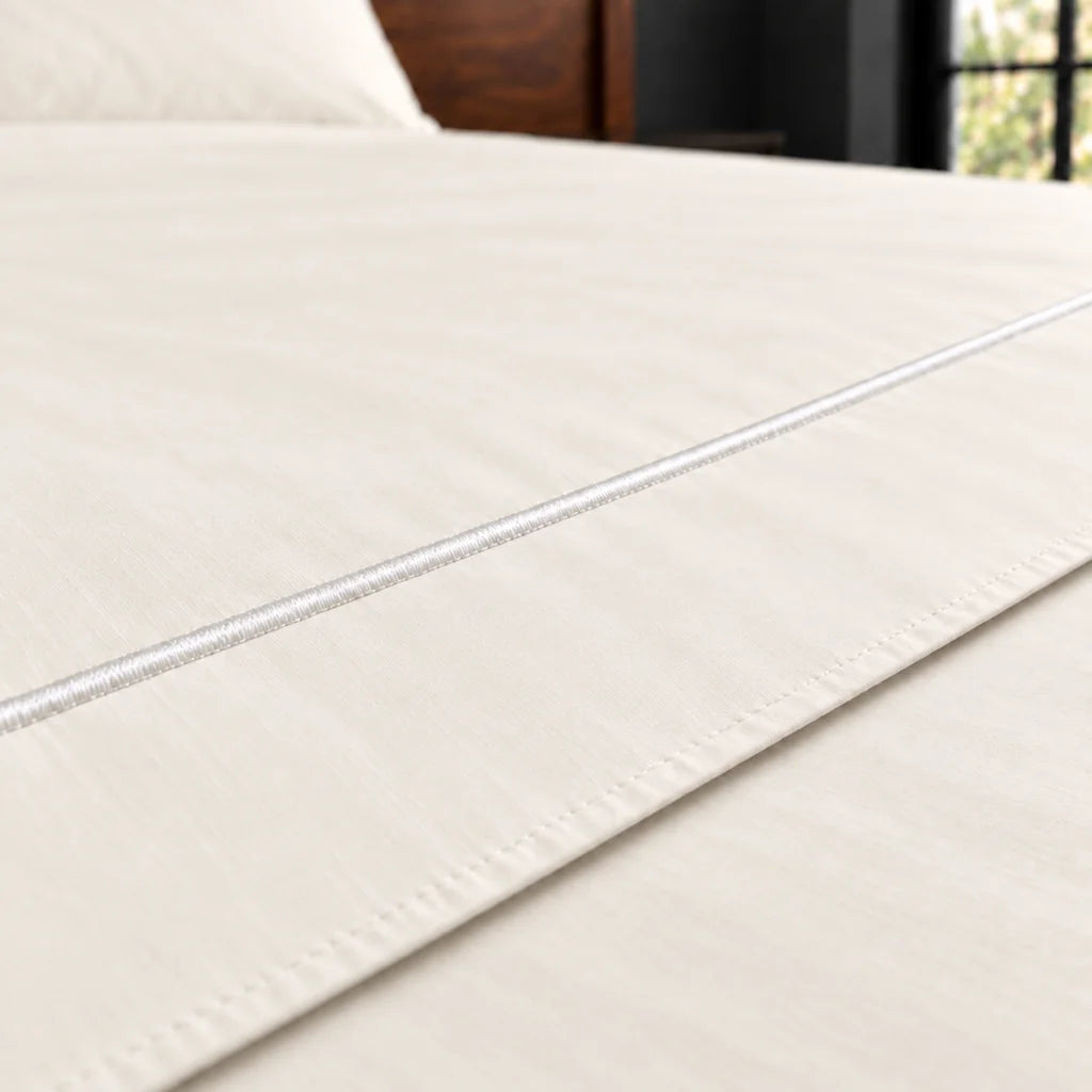 cream polycotton percale 200tc flat sheet, one row white satin stitch — close up — Linen and Co