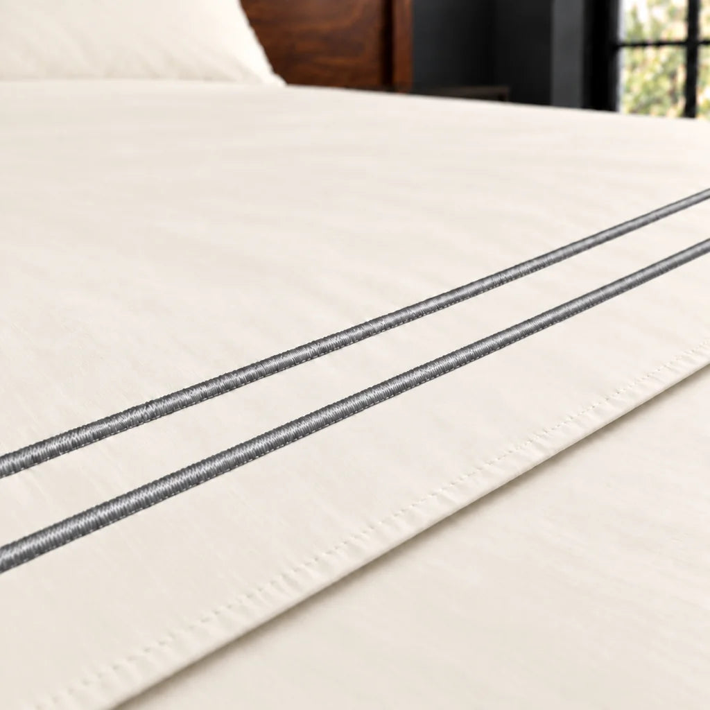 cream polycotton percale 200tc flat sheet, two row grey satin stitch — close up — Linen and Co