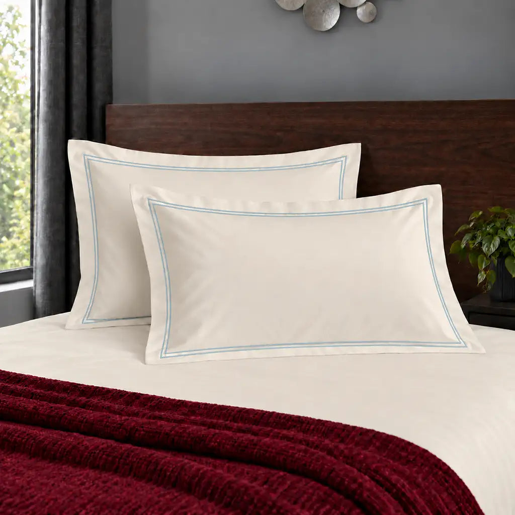 Oxford cream 200TC polycotton percale pillowcases with two row duck egg satin stitch border by Linen and Co