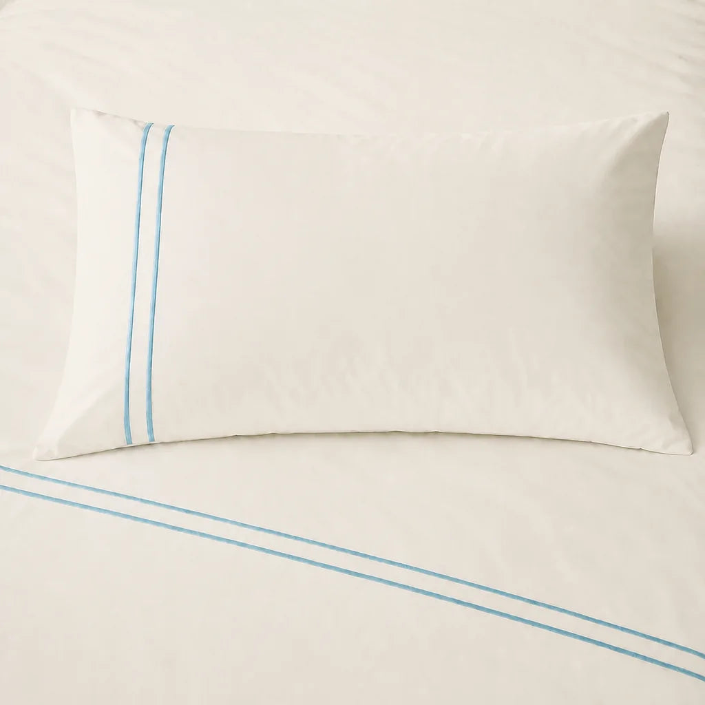 Cream 200TC cotton percale plain duvet cover set with Duck Egg two row satin stitch - on the bed - Linen and Co