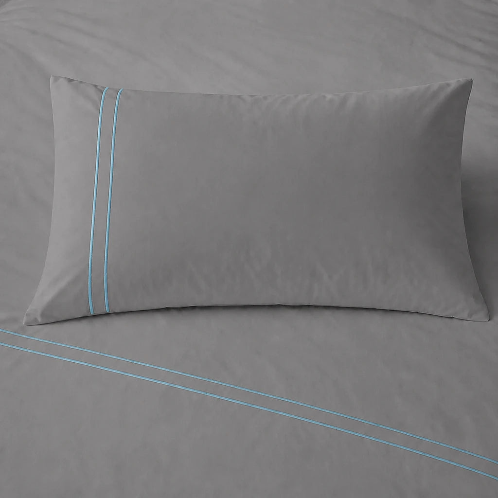 Grey 200TC cotton percale plain duvet cover set with Duck Egg two row satin stitch - pillow on bed - Linen and Co