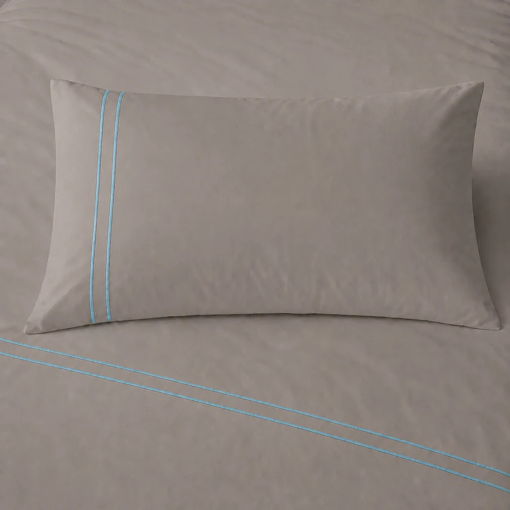 Stone 200TC cotton percale plain duvet cover set with Duck Egg two row satin stitch - pillow on bed - Linen and Co